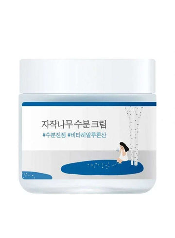 Creme hidratante coreano em pote branco com ilustração de bétula e menina, rotulagem em coreano.