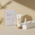 Conjunto de cuidados de pele coreano iUNIK Black Snail, com creme e mini sérum, em fundo bege.